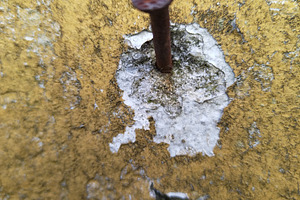 Rusty nail embedded in peeling yellow wall, a Background Photo by DanFLCreativo