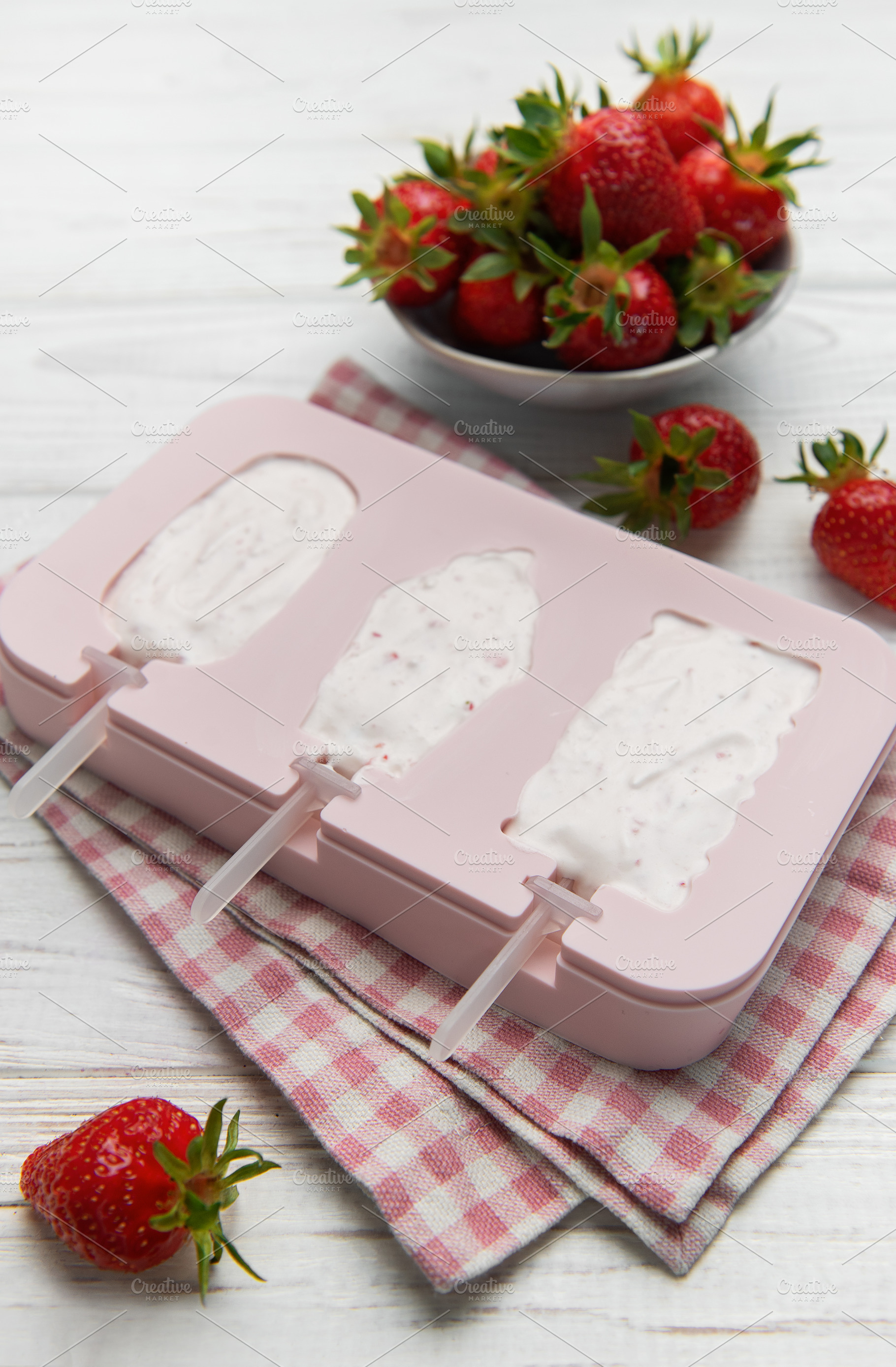 Making homemade strawberry ice cream popsicles in silicone mold, a Food & Drink Photo by Olena Rudo