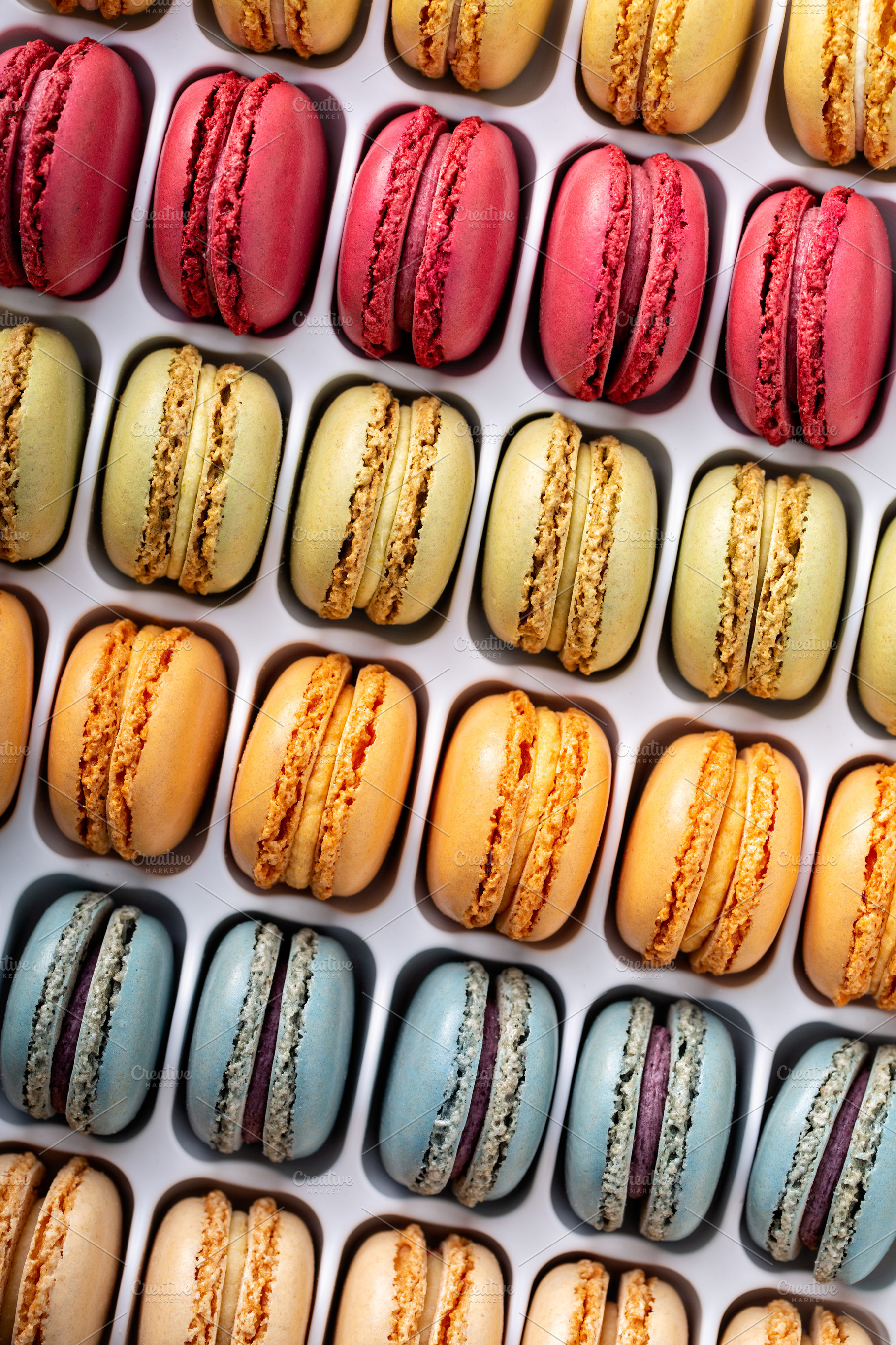Colorful french macarons in a box, a Food & Drink Photo by farwasser