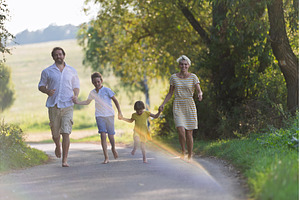 A family with small children running, a Person Photo by HalfPoint