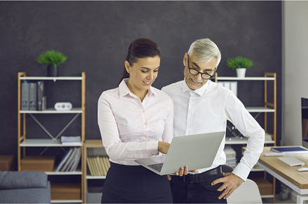 Two business people standing in, a Business Photo by StudioRomantic