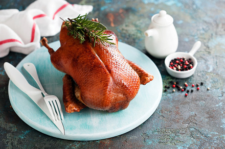 Whole crispy golden roast duck on a