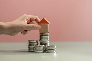 Placing small house model on stacked coins. Saving money, home o, a Photo by salmon.black