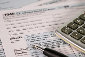 Tax form and calculator on table wit, a Business Photo by 1miromiro