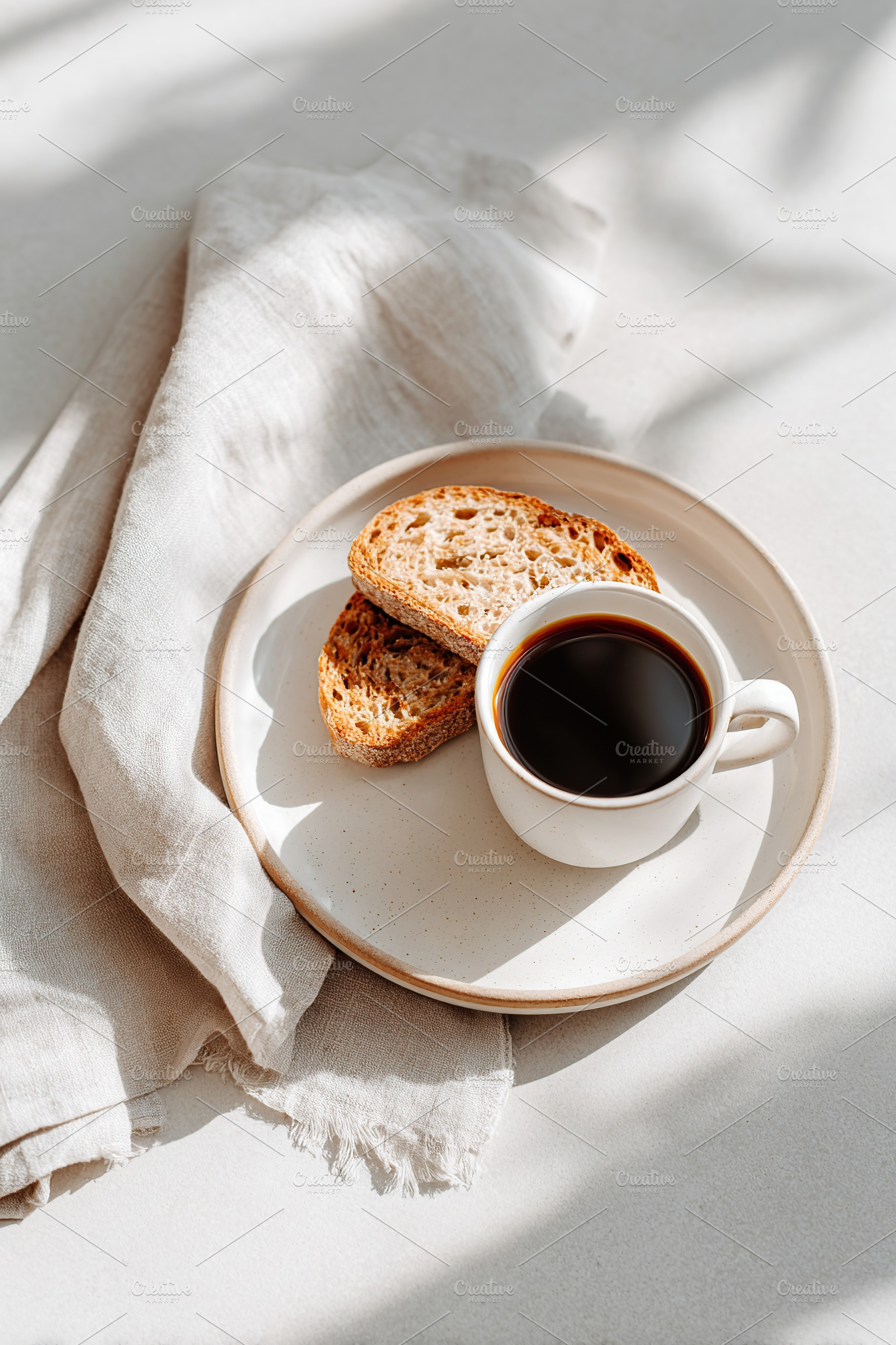 Morning coffee and toasted bread served on a plate in warm sunlight setting, a Food & Drink Photo by AlyaAnd
