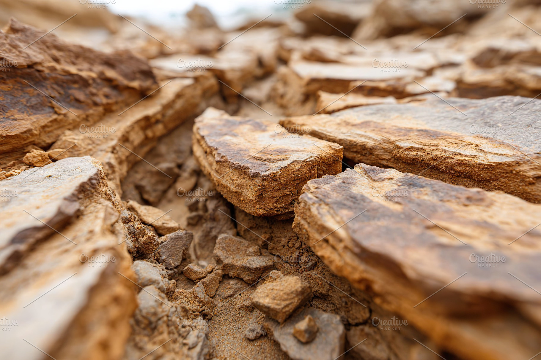 Dried-up riverbed reveals cracked earth and exposed rocks in a desolate landsca, a Nature Photo by AlyaAnd