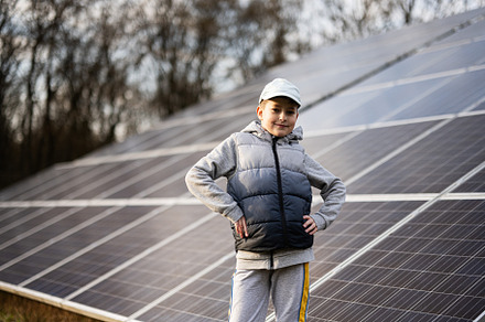 Boy child on the background of solar panels.  Eco energy., a Technology Photo by AS photostudio