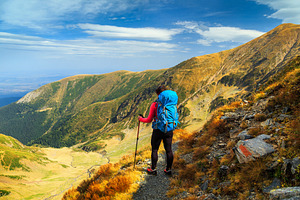 Hiker woman with backpack in Fagaras, a Sports & Recreation Photo by Alpine Dreams