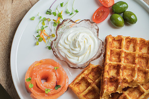 Crunchy waffle fries with sour cream dip served in a basket, a Food & Drink Photo by Budarinphoto