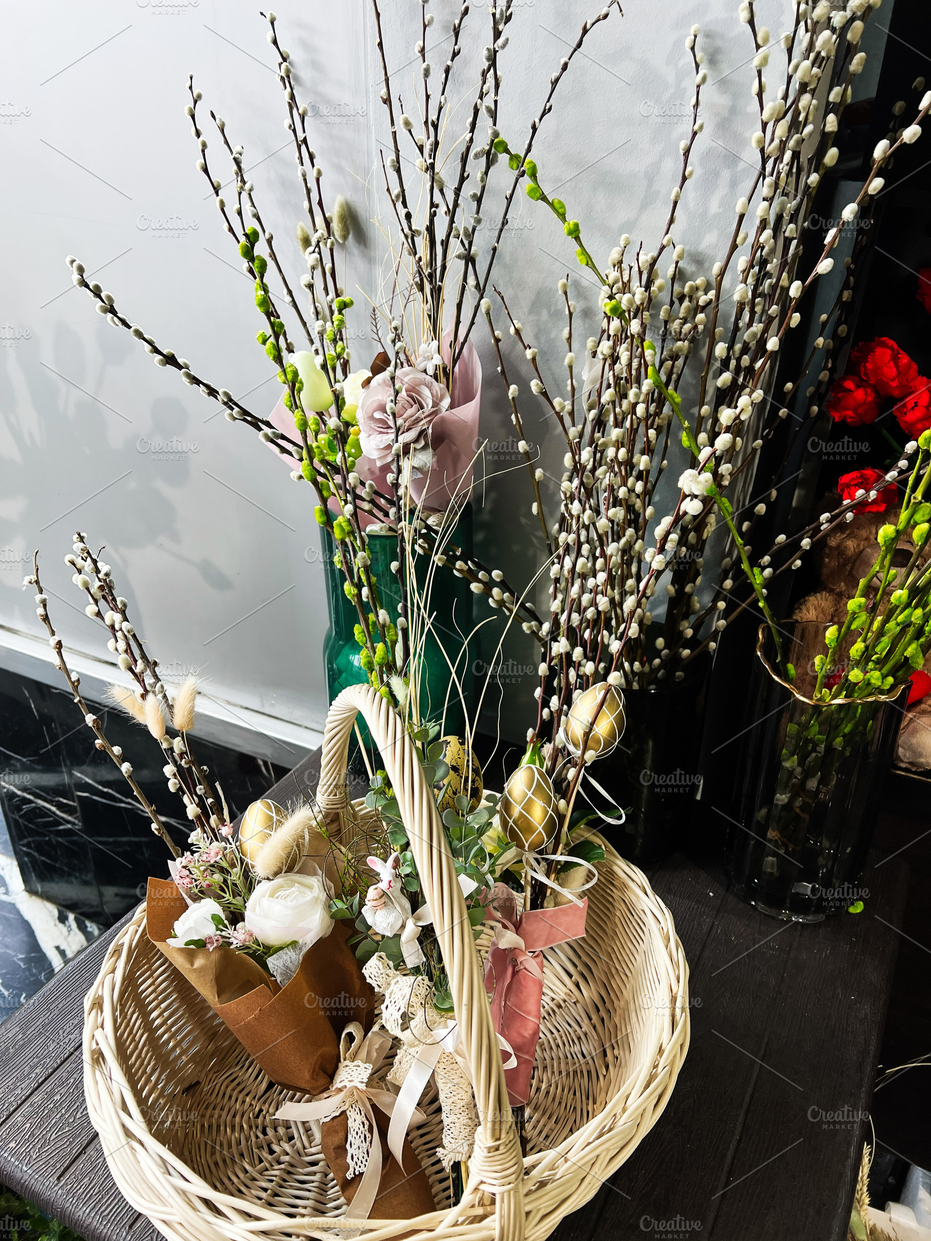 Rustic basket adorned with floral arrangements and natural willow branches, a Photo by AS photostudio