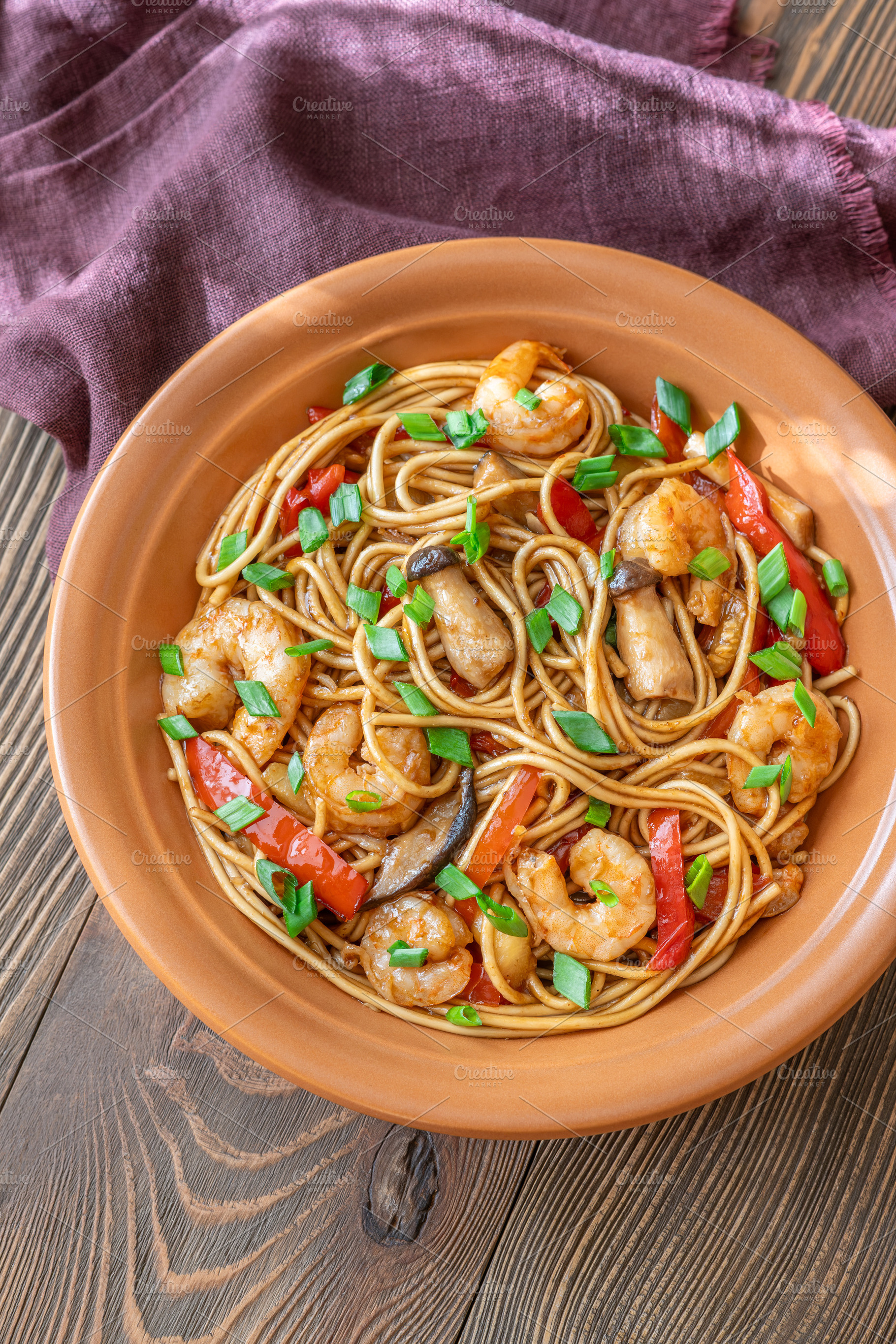 Asian stir fry udon noodles with prawns mushrooms vegetables in, a Food & Drink Photo by Alexander Prokopenko