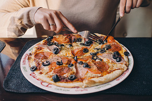 Woman eating delicious pizza