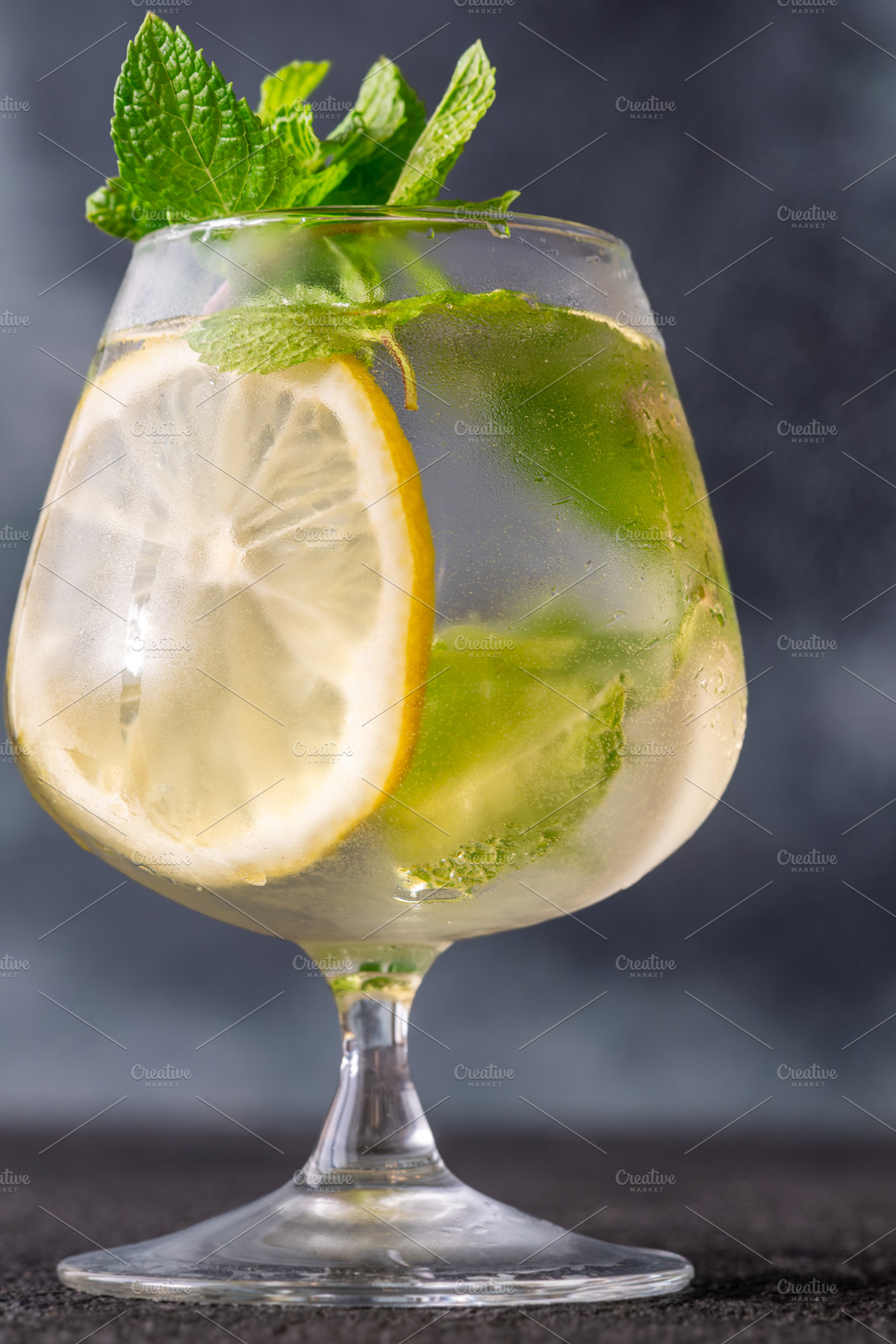 Refreshing Hugo Spritz cocktail with lemon mint ice bubbles and, a Food & Drink Photo by Alexander Prokopenko