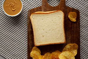 Homemade American Peanut Butter Sandwich on a Wooden Board, top, a Food & Drink Photo by LiudmylaChuhunova
