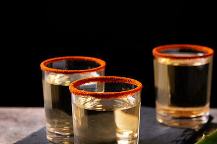 Mezcal Mexican drink with worm salt on wooden table, a Food & Drink Photo by etorres69