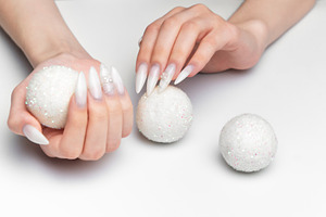 Woman hands holding sparkling christmas ornaments with long nail, a Beauty & Fashion Photo by Olena Rudo