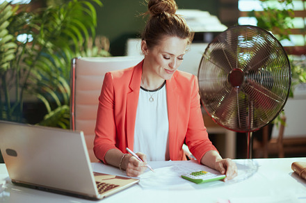 modern accountant woman in modern green office in red jacket, a Business Photo by Alliance Images