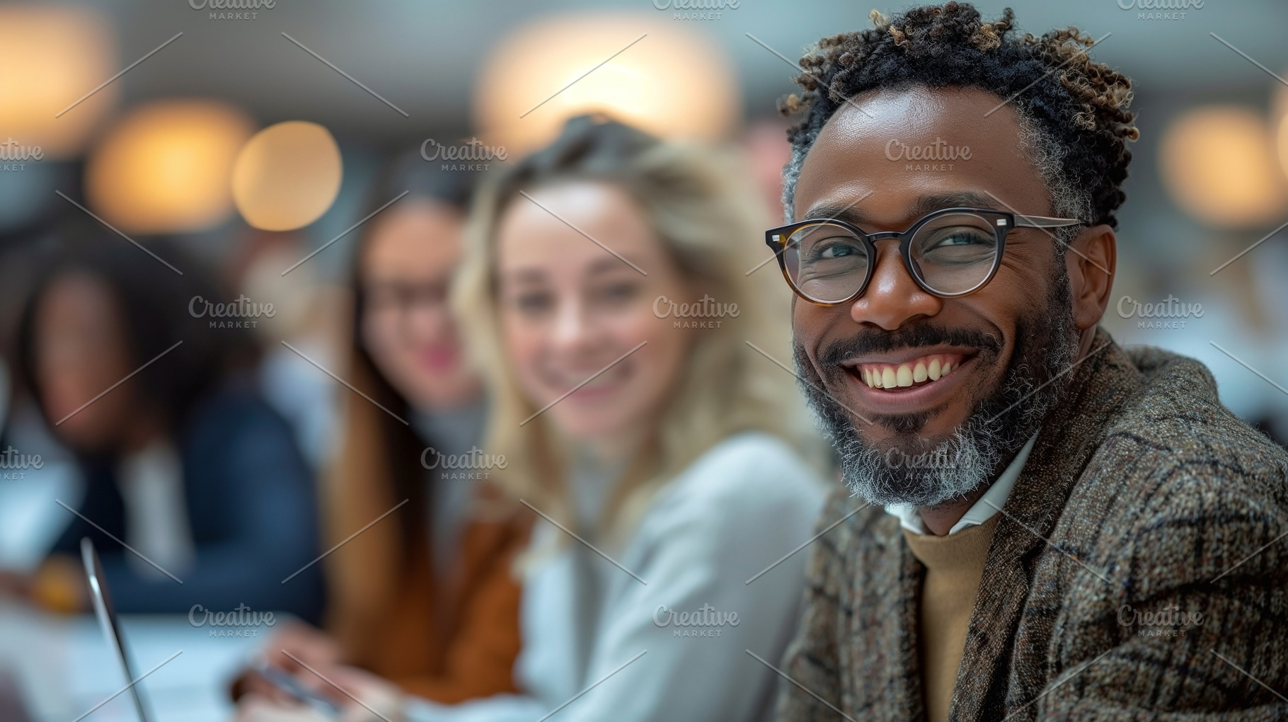 Smiling African American man in glasses at a conference, surrounded by engaged, a Person Photo by ImageMir