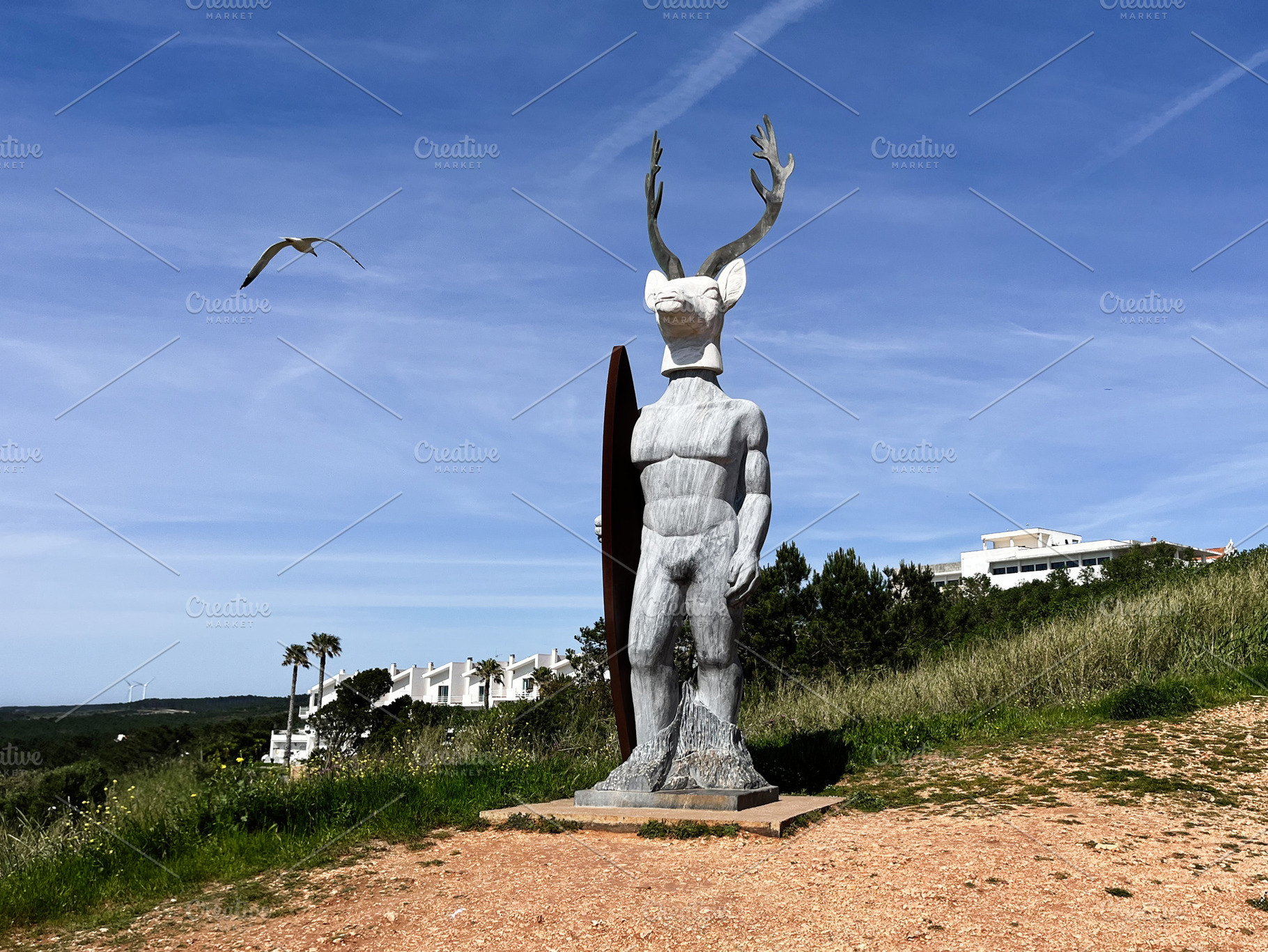 Intriguing statue in Nazare Portugal with blue sky and open landscape, a Photo by AS photostudio