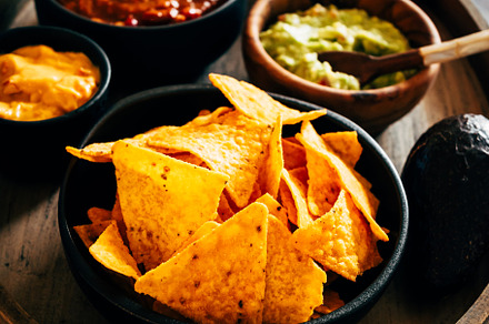 Mexican nachos with guacamole, cheddar cheese and chili.