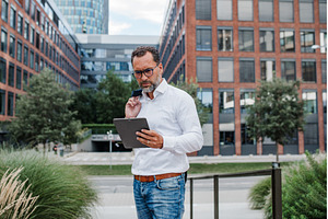 Businessman in front of office, a Person Photo by HalfPoint