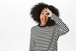 Excited young african woman shows