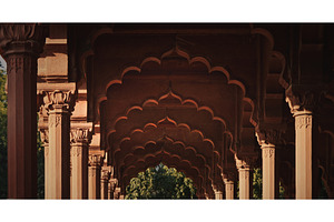 Intricate carved capitals and red, an Architecture Photo by Our Amazing World