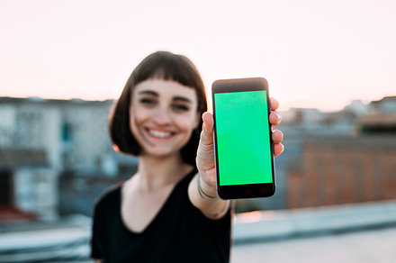 Young woman smiles with phone featuring background, woman, and technology, a Technology Photo by DeRepente