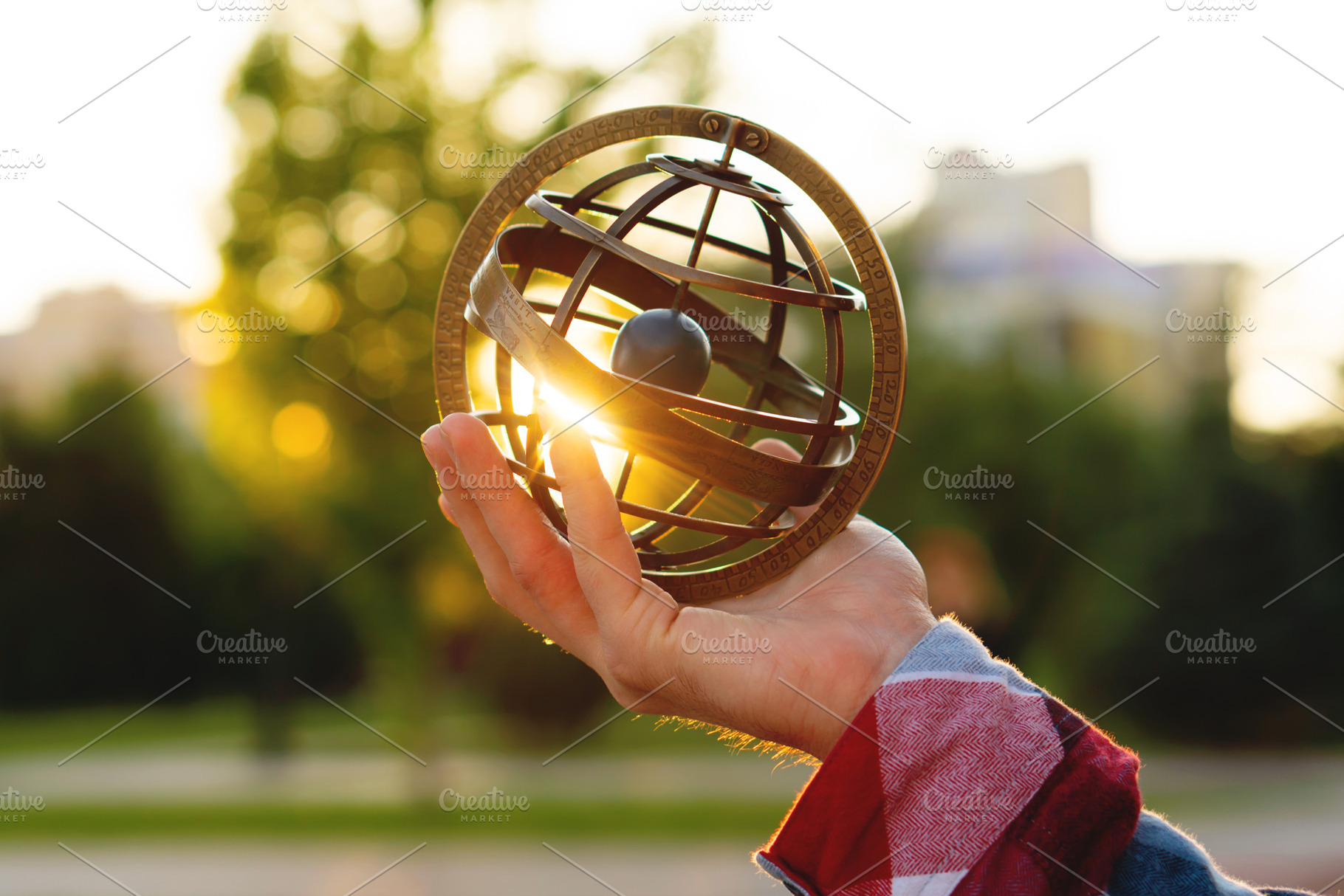 Person holding vintage armillary sph, a Background Photo by Elena Vagengeim