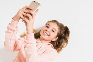 Smiling teen girl taking selfie