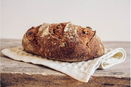 Brown fresh bread with seeds on old, a Food & Drink Photo by olhovyi_photographer
