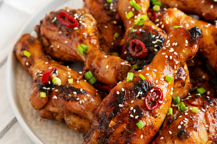 Homemade Easy Sticky Chicken Drumsticks on a Plate, side view. C, a Food & Drink Photo by LiudmylaChuhunova