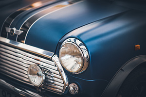 Headlamps and grille of a blue car