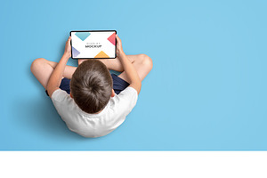 Boy Holding Tablet Mockup Top View