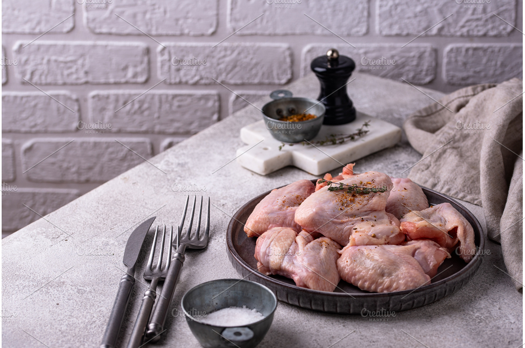 Raw chicken wings on black, a Food & Drink Photo by Yulia Furman