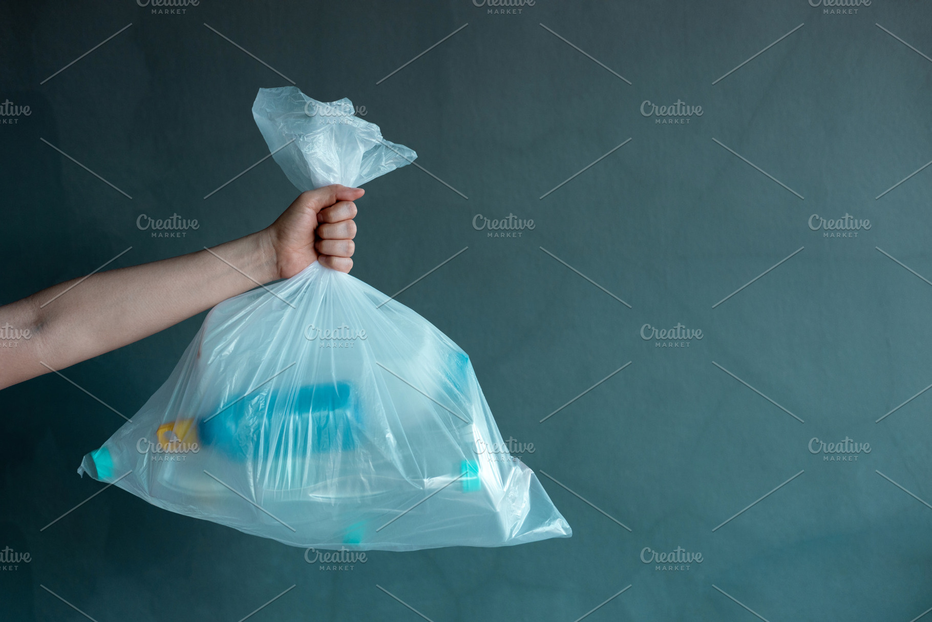 Hand holding plastic waste bag filled with bottles, Recycling an, a Photo by salmon.black