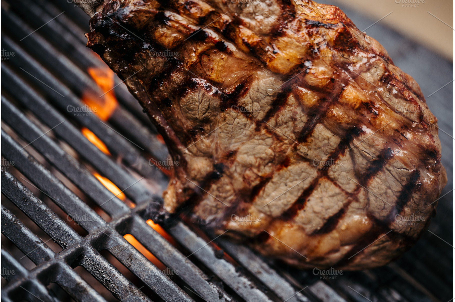 Grilling New York Strip steak over, a Food & Drink Photo by HalfPoint