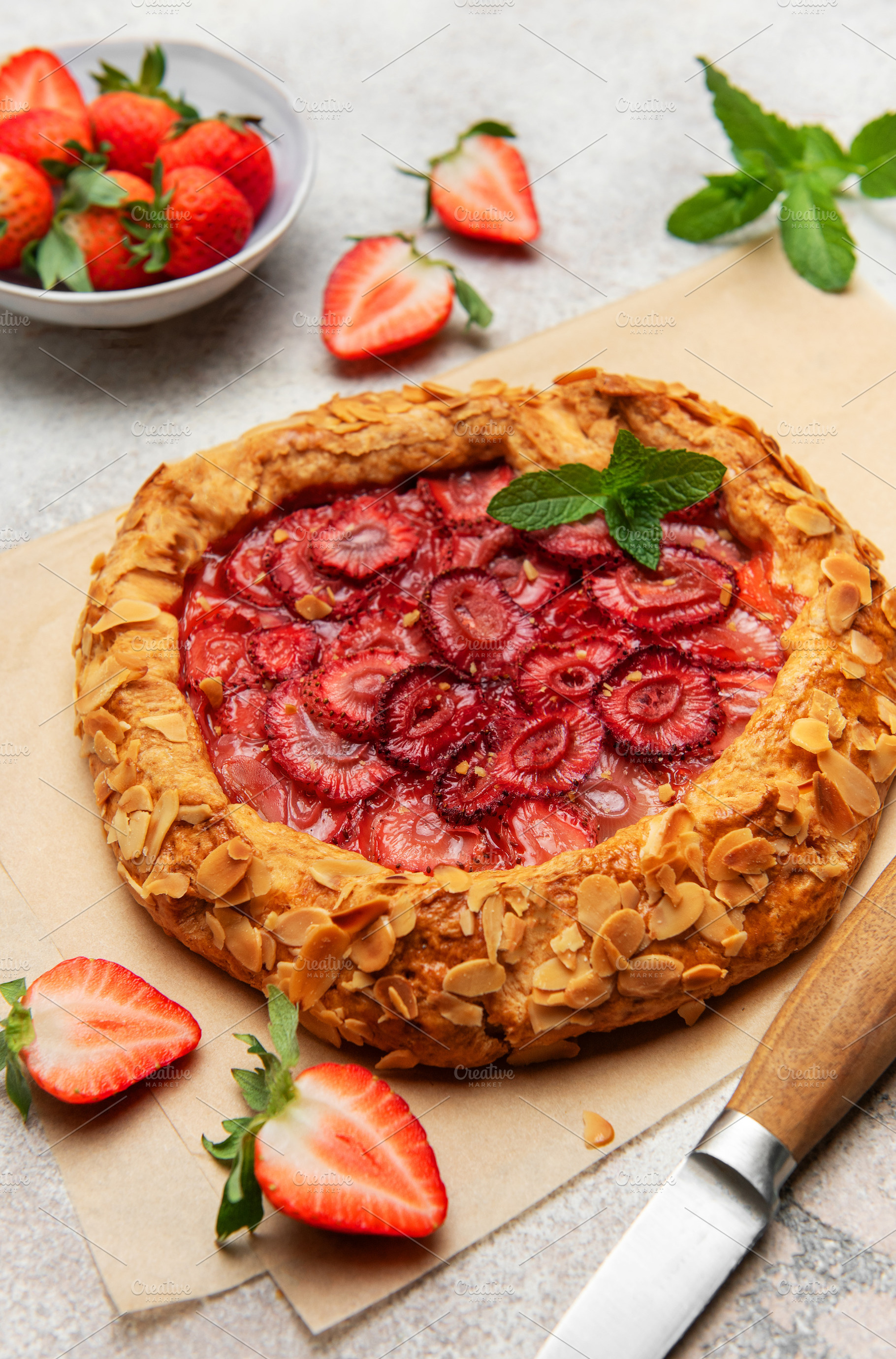 Delicious homemade strawberry galette with almond petals and fre, a Food & Drink Photo by Olena Rudo