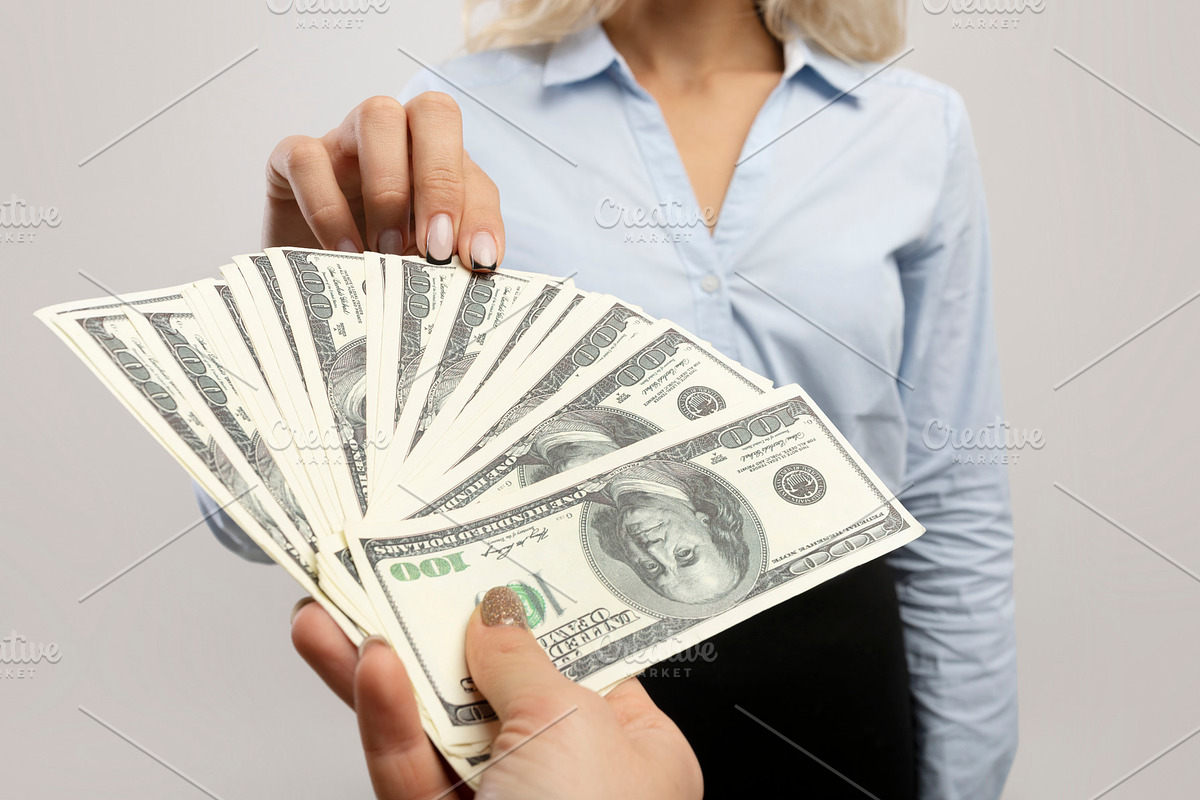 Corruption and bribery concept. Lady giving money to businesswoman over light g, a Photo by Prostock-Studio (Photo 2 of 2)