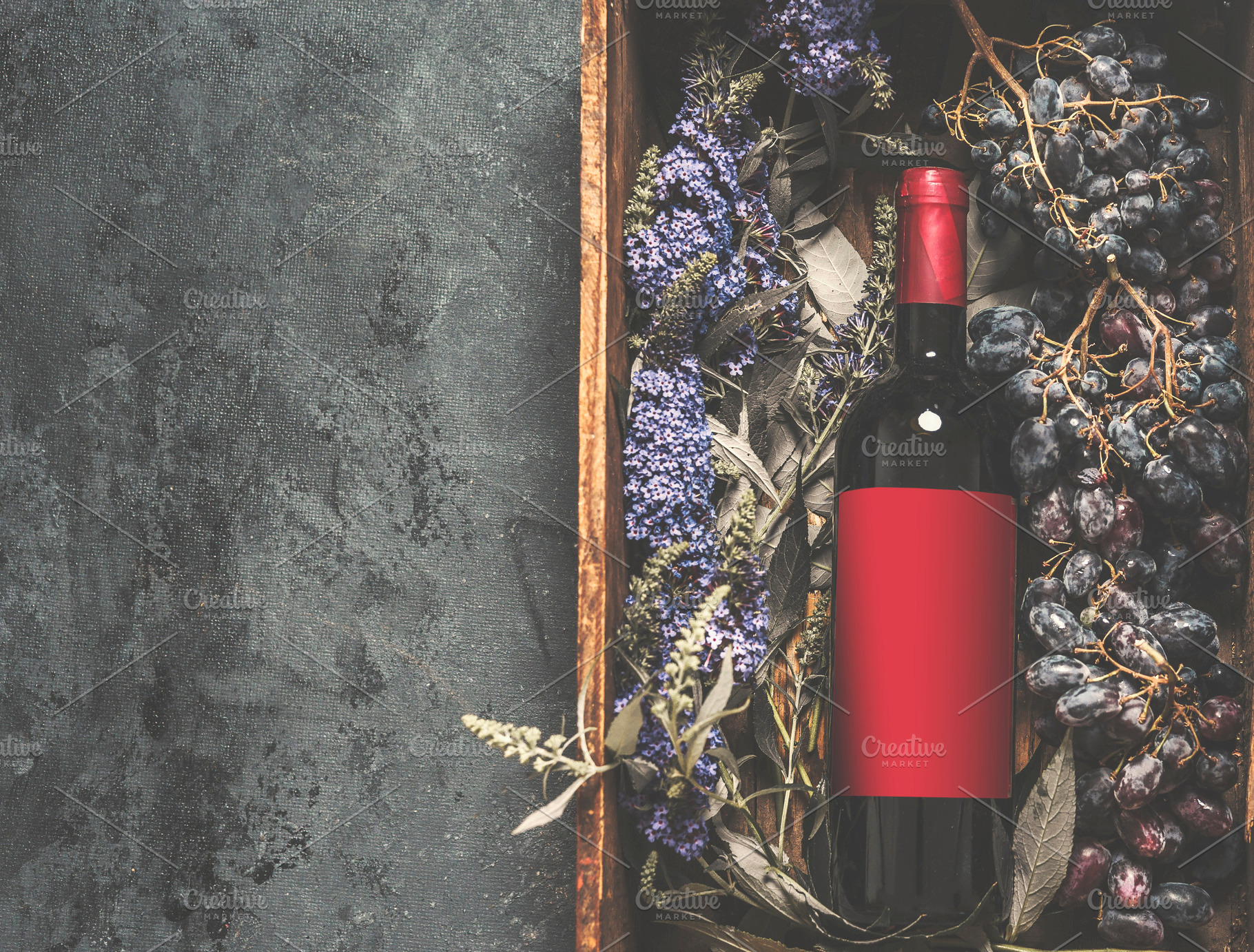 Red wine bottle with empty red label, a Food & Drink Photo by VICUSCHKA