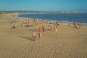 Wide shot of a crowded beach on a sunny day, a Person Photo by DanFLCreativo