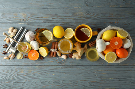 Concept of treatment colds with honey and garlic on gray  wooden, a Health & Medical Photo by AtlasStudio PRO