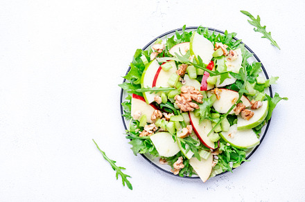 Waldorf salad with red and green apple, green celery, lettuce, a, a Food & Drink Photo by 5PH
