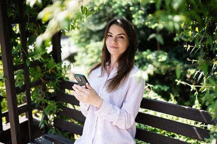 Young freelancer woman in shirt sit on bench in summer park outd, a Person Photo by AS photostudio