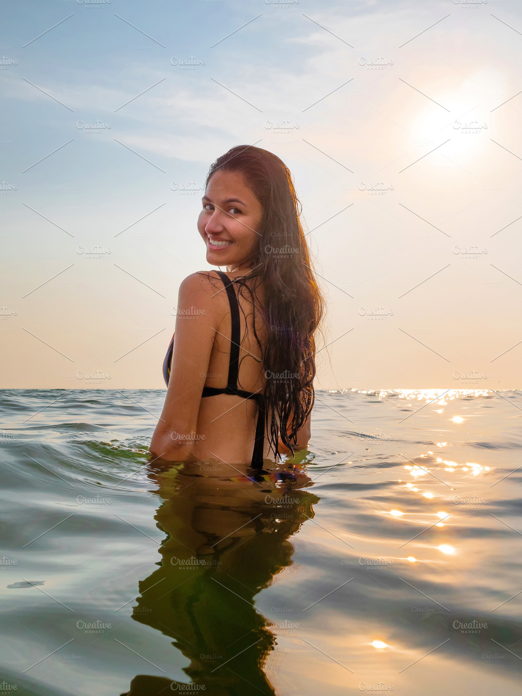 Young woman in bikini takes a bath in the sea at sunset lights i, a Person Photo by Antonio Gravante Market