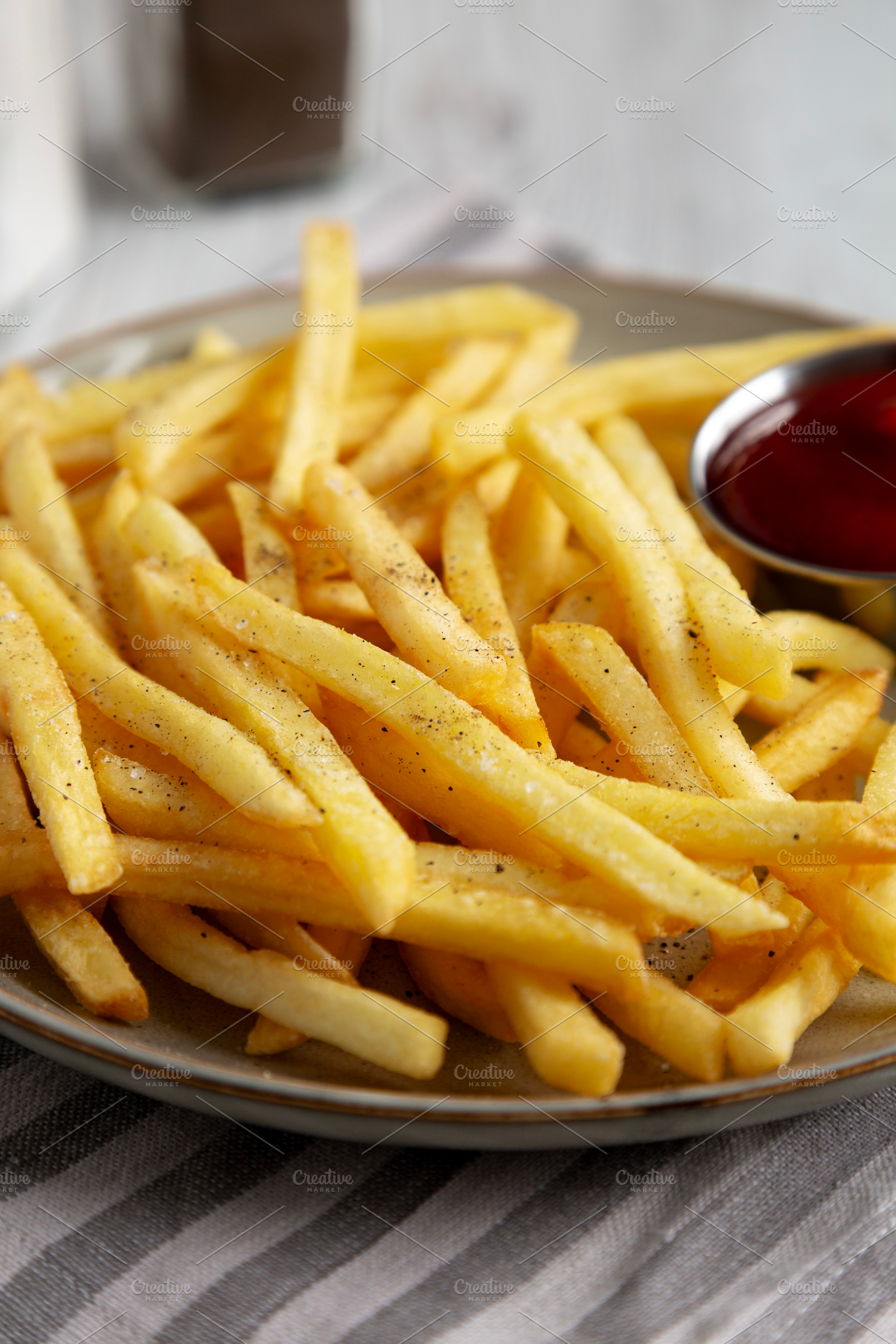 Homemade French Fries and Ketchup on a Plate, low angle view. Cl, a Food & Drink Photo by LiudmylaChuhunova