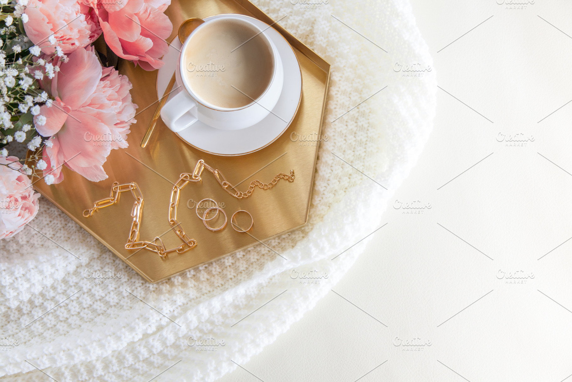 White cup of coffee and decorations on a golden tray in the nord, a Business Photo by Natalia Kostikova