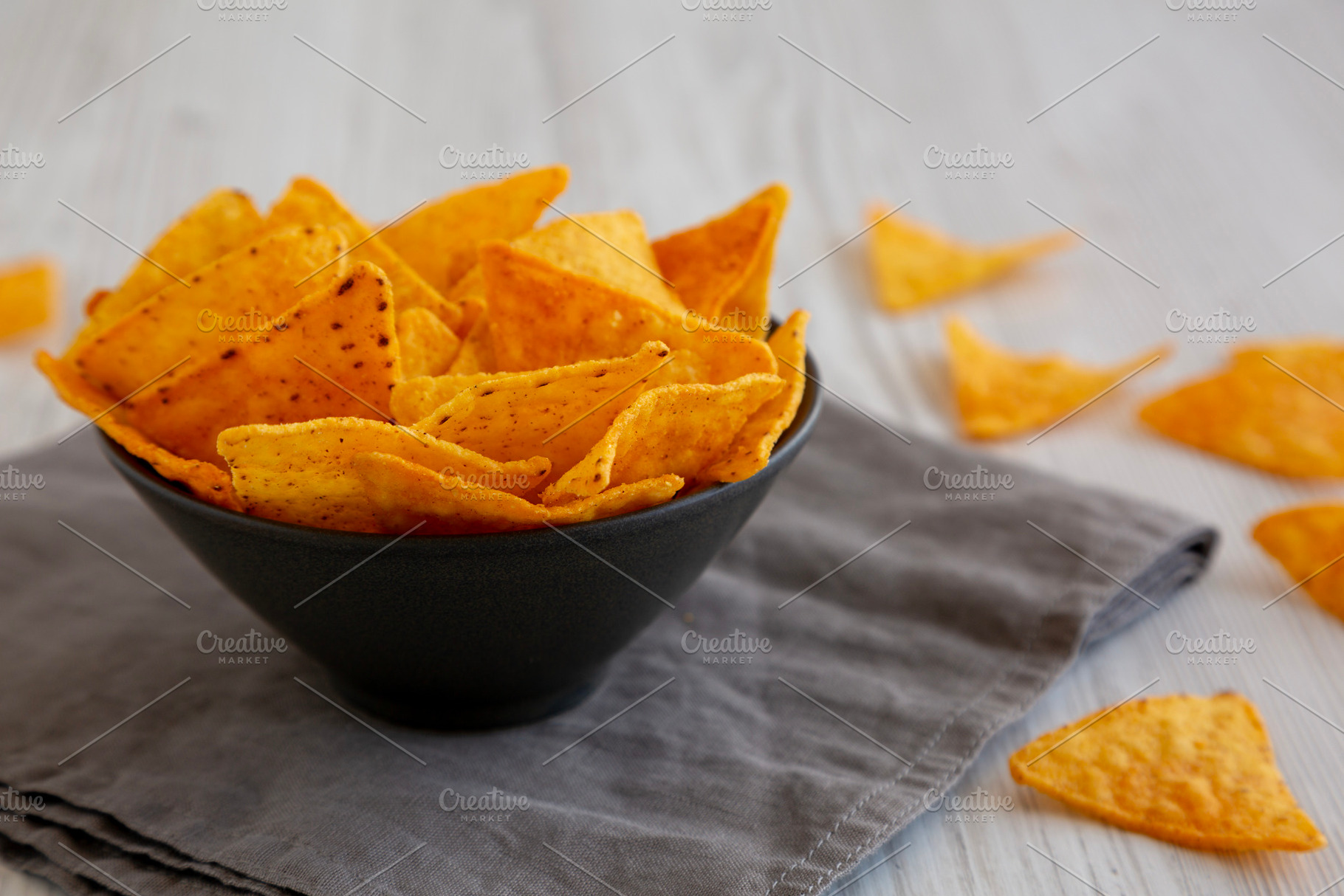 Crunchy Nacho BBQ Tortilla Chips in a Bowl, side view. Close-up., a Food & Drink Photo by LiudmylaChuhunova