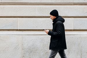 Modern man walking along a city, a Person Photo by MistyDay
