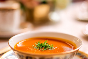 Gourmet butternut squash soup with fresh dill in a luxury hotel, a Photo by Studio ANNA